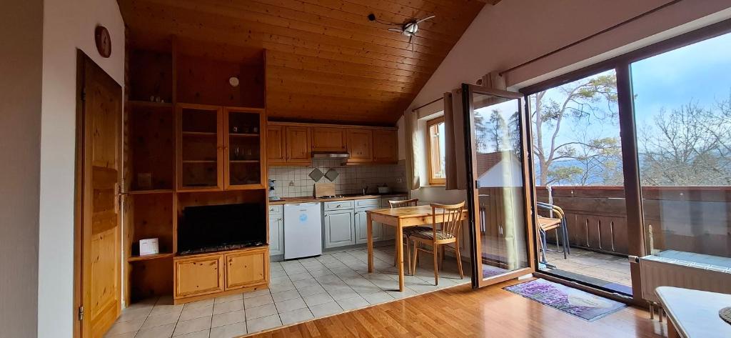 a kitchen with white appliances and a large window at Donaublick Möhringen in Tuttlingen
