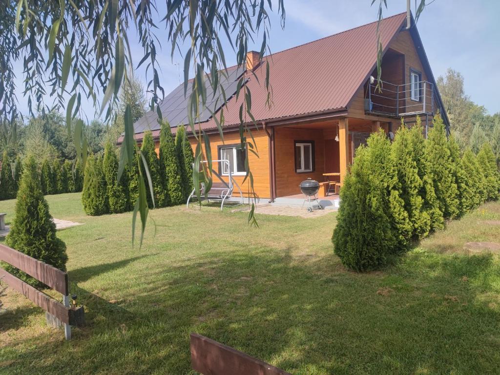 a house with a large yard in front of it at Domki Helena Okuninka in Okuninka