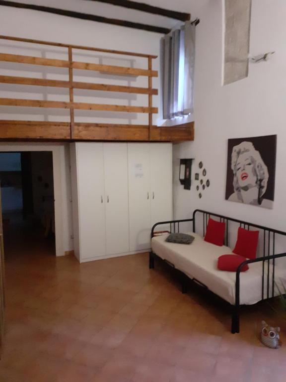 a bedroom with a bed with red pillows on it at Casa Normanna in Salerno