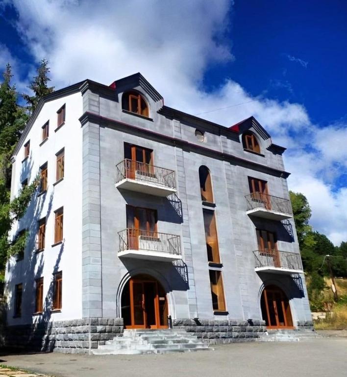 a large white building with windows on the side of it at Jermuk Villa Imperial in Jermuk