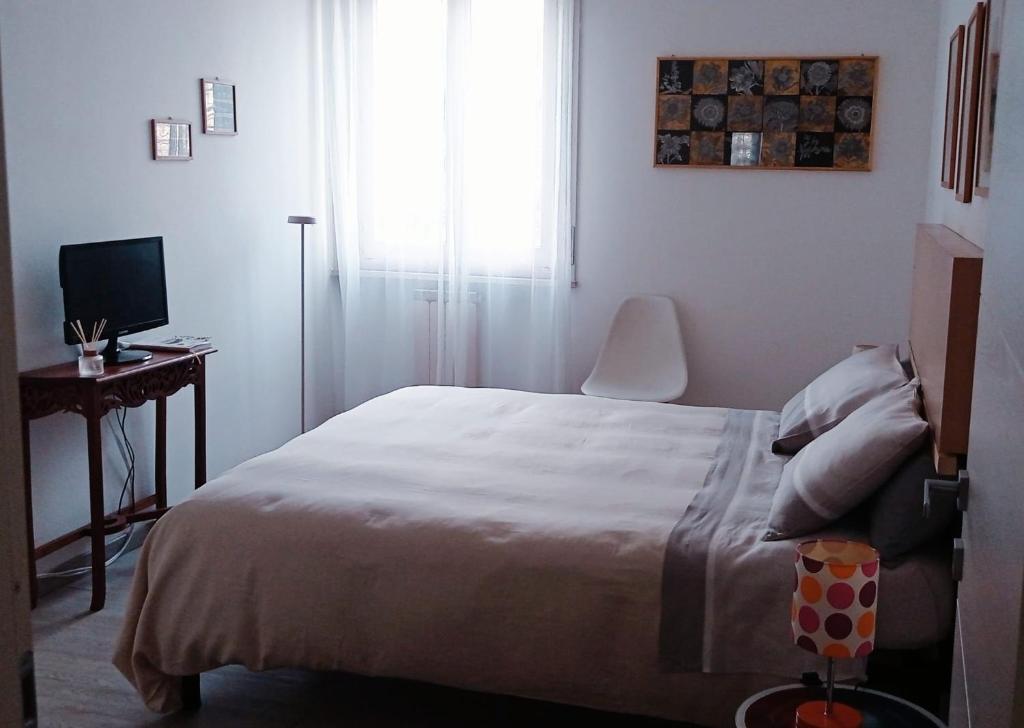 a bedroom with a bed and a desk with a computer at Teatro degli Etruschi in Perugia