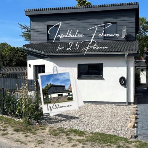 a building with a sign in front of it at Inselbutze Fehmarn in Fehmarn