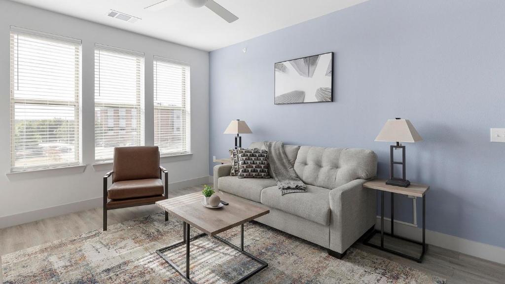 a living room with a couch and a chair at Landing Stunning 2BD in Corinth in Denton