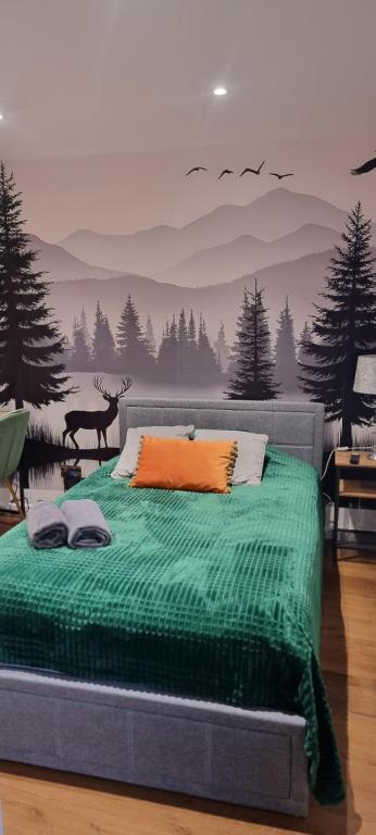 a bedroom with a green bed with a deer on it at Private Studio Suite, 24h Self Check-in in Luton