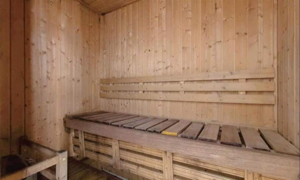 a wooden cabin with a bed in the corner at Birch Tower Condominium Malate in Sampong