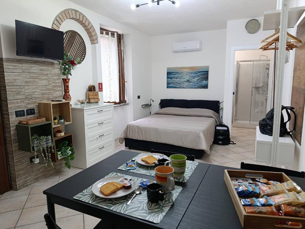 a room with a bed and a table with food on it at Palma's house in Cambiago