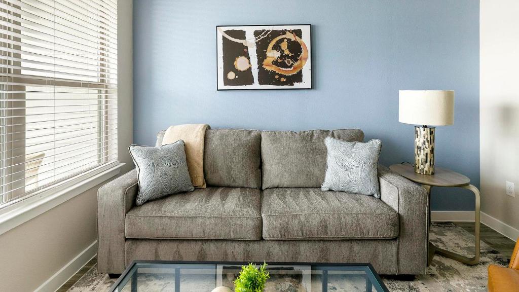 a living room with a couch and a table at Landing Incredible 1BD Pool Gym in Katy