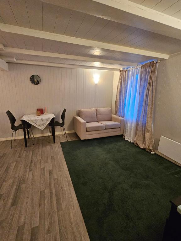 a living room with a couch and a table at Salhusvegen in Bergen