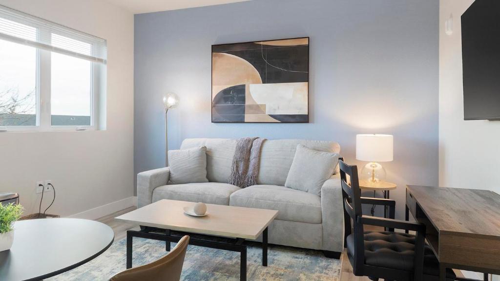 a living room with a couch and a table at Landing Apartments - 2720 S Federal in Englewood