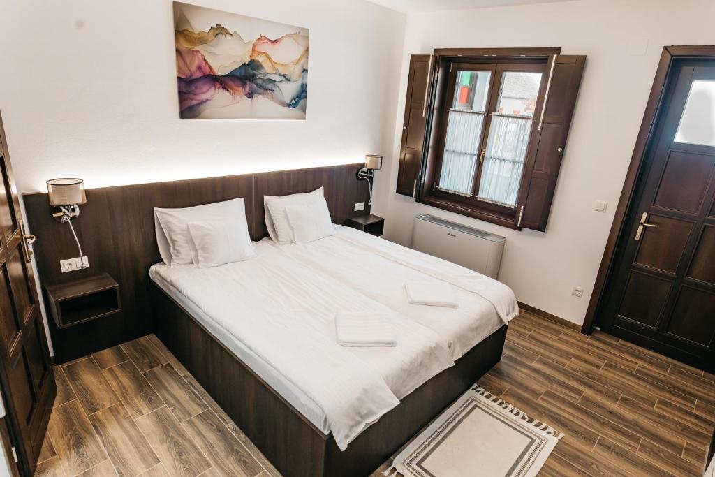 a bedroom with a large bed in a room at Szende Vendégház in Villány