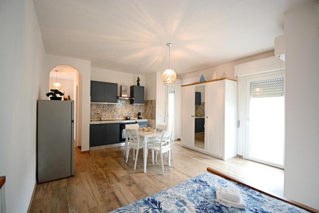 a kitchen and dining room with a table and a refrigerator at Fidelica in Stintino