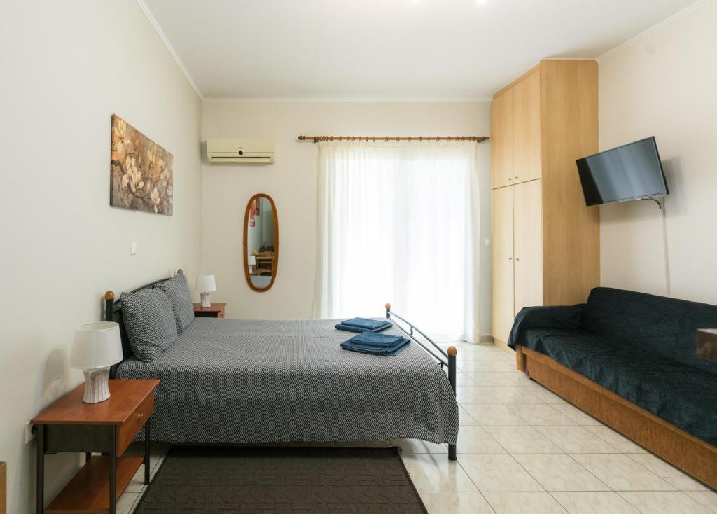 a bedroom with a bed and a couch at Central Cozy Apartment 3 in Sparta