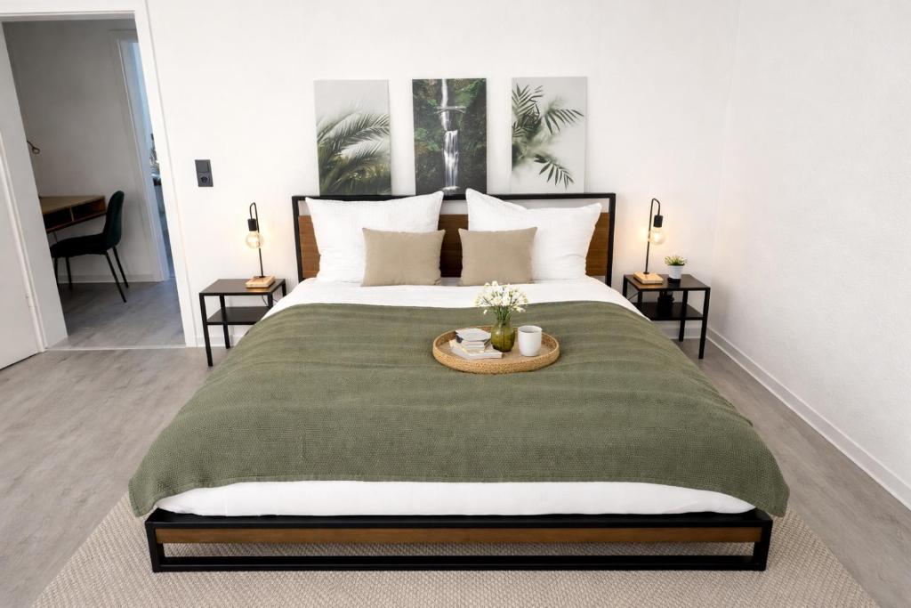 a bedroom with a large bed with a table on it at N&N Apartments - Studio mit Netflix - Workstation im Zentrum in Schwerin