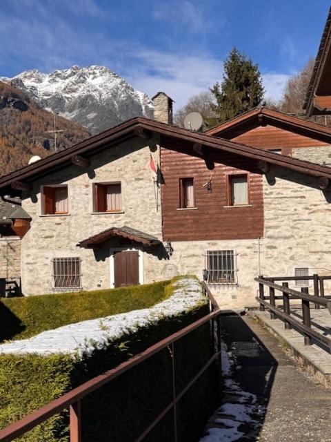 a building with a snowcovered mountain in the background at Cà de l'Angel in Torre di Santa Maria
