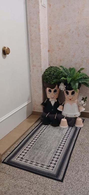 two dolls are standing in front of a door at Meri per sempre in Pontebba