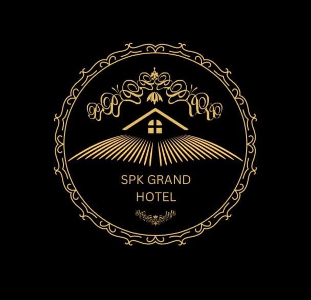 a luxury hotel logo with a gold crest on a black background at Spk grand hotel in Rushikonda