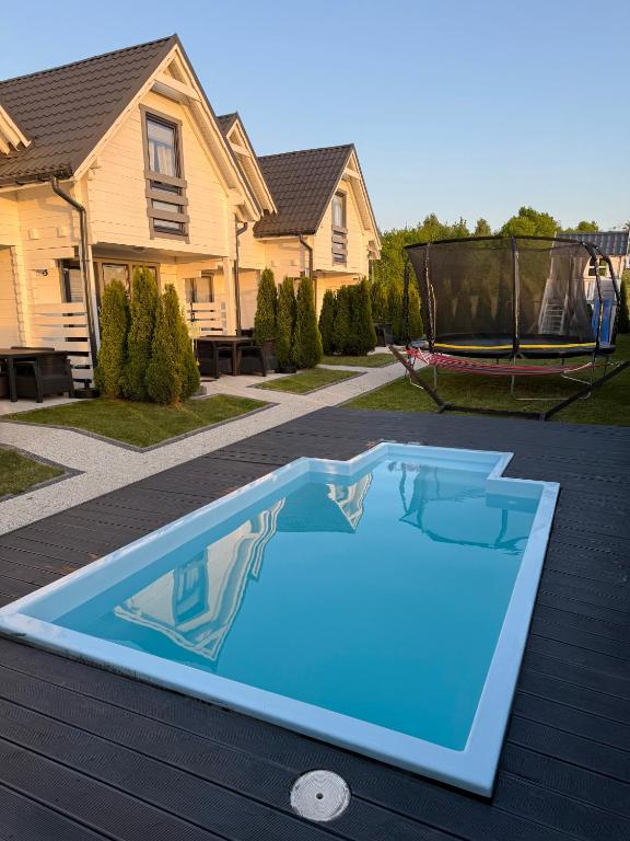a swimming pool in the backyard of a house at Sarbinówka23 in Sarbinowo