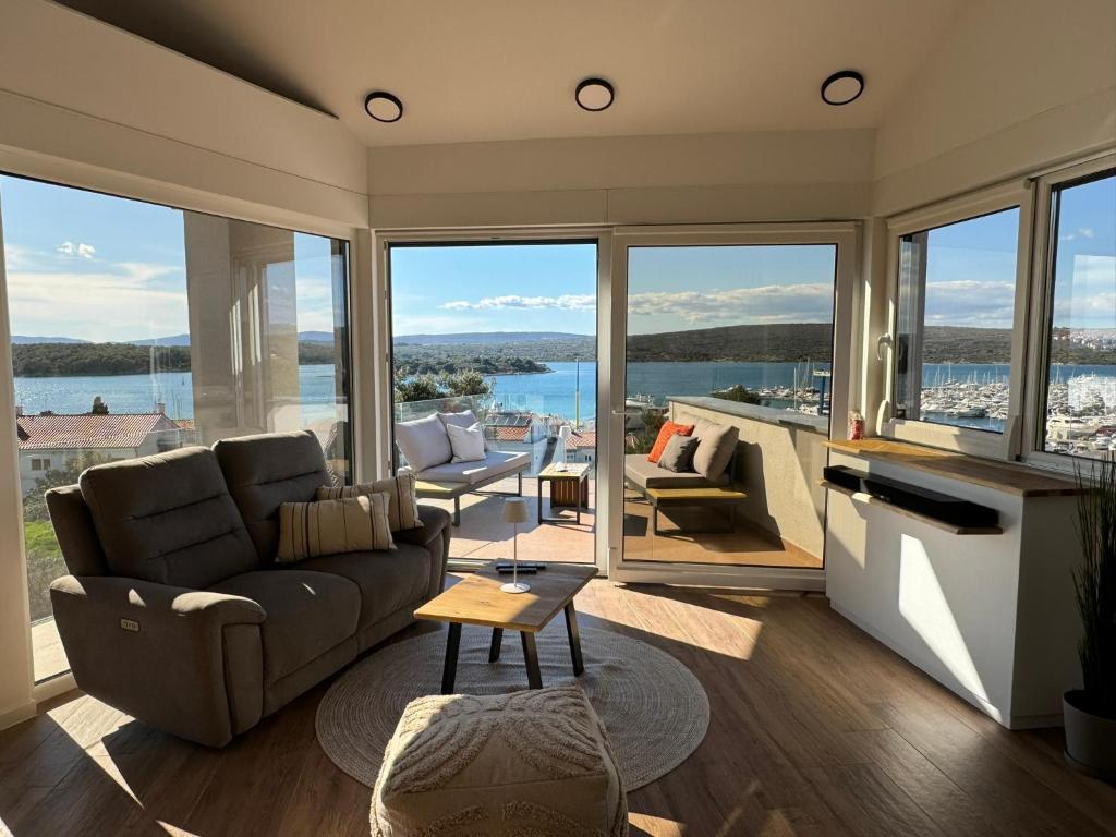 a living room with a couch and a table at Marina Penthouse in Punat