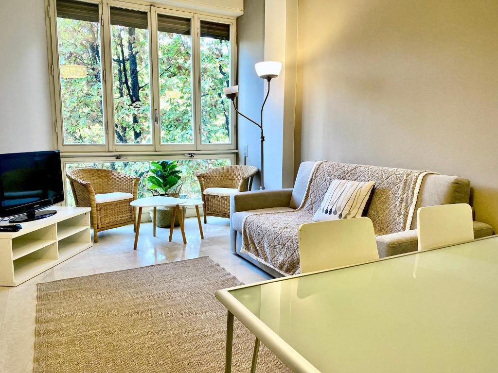 a living room with a couch and chairs and a tv at Anna Home Gallarate train station to Milan Malpensa self-check-in in Gallarate