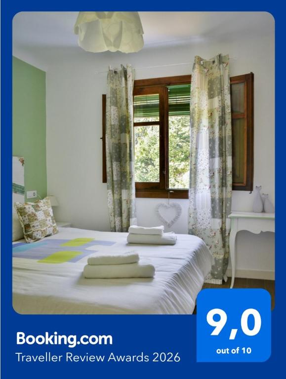 a bedroom with a bed with towels on it at El Rincón de Elsa VuT AV296 in Guisando