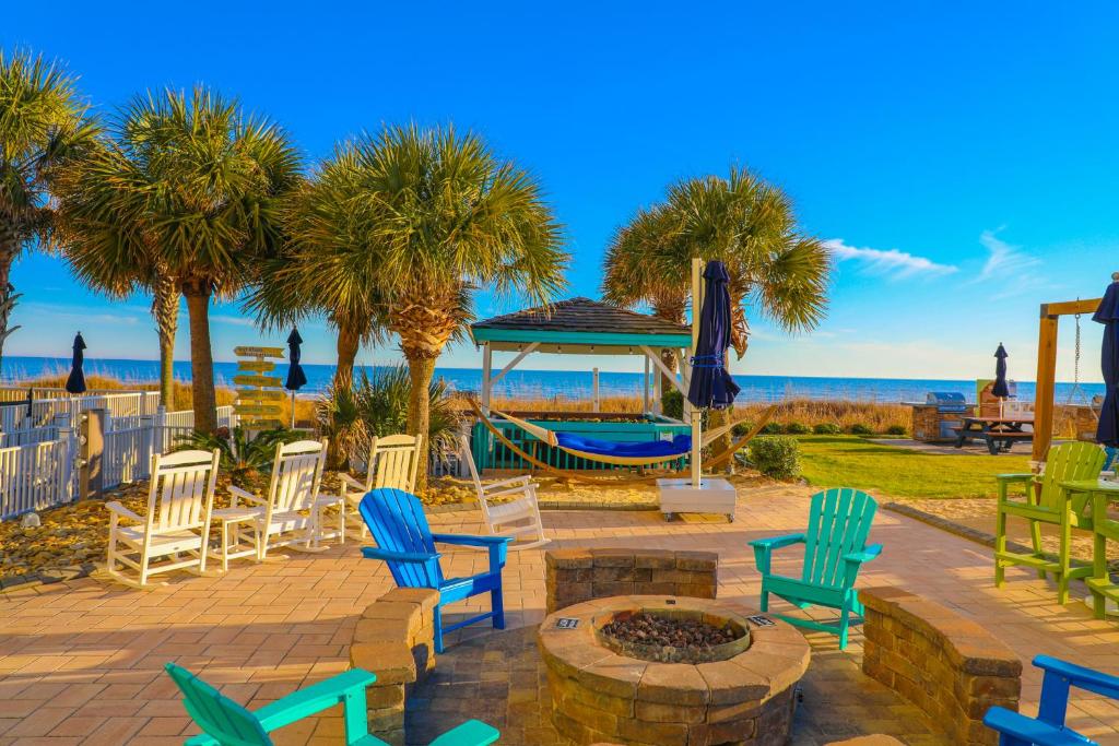 a group of chairs and a fire pit on the beach at Towers at North Myrtle Beach in Myrtle Beach