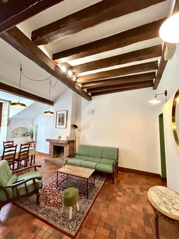 a living room with a couch and a table at Loft Blois Cathédrale 2 Chambres in Blois