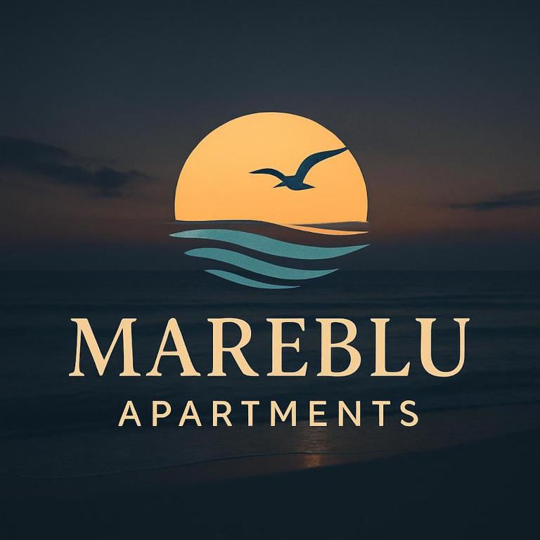 a bird flying over the ocean with a sunset at Mareblu Apartments Grado in Grado