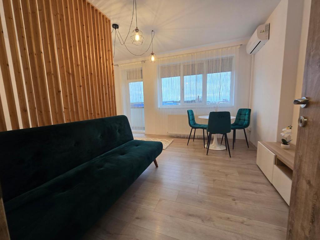 a living room with a couch and a table at Merci Apartament 2,0 in Sibiu