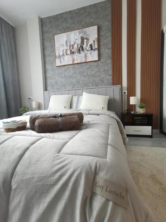 a large white bed with two pillows on it at Bella Apartment in Ruse