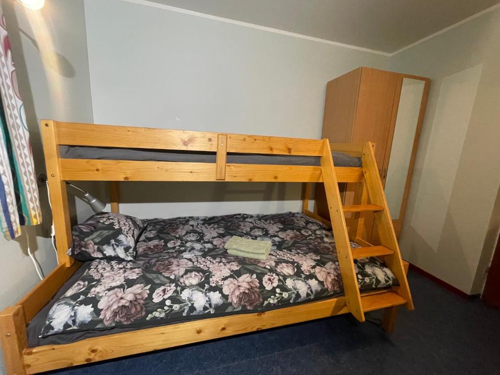 a bunk bed in a room with a flowery bed at Laplanders room 4 in Kiruna
