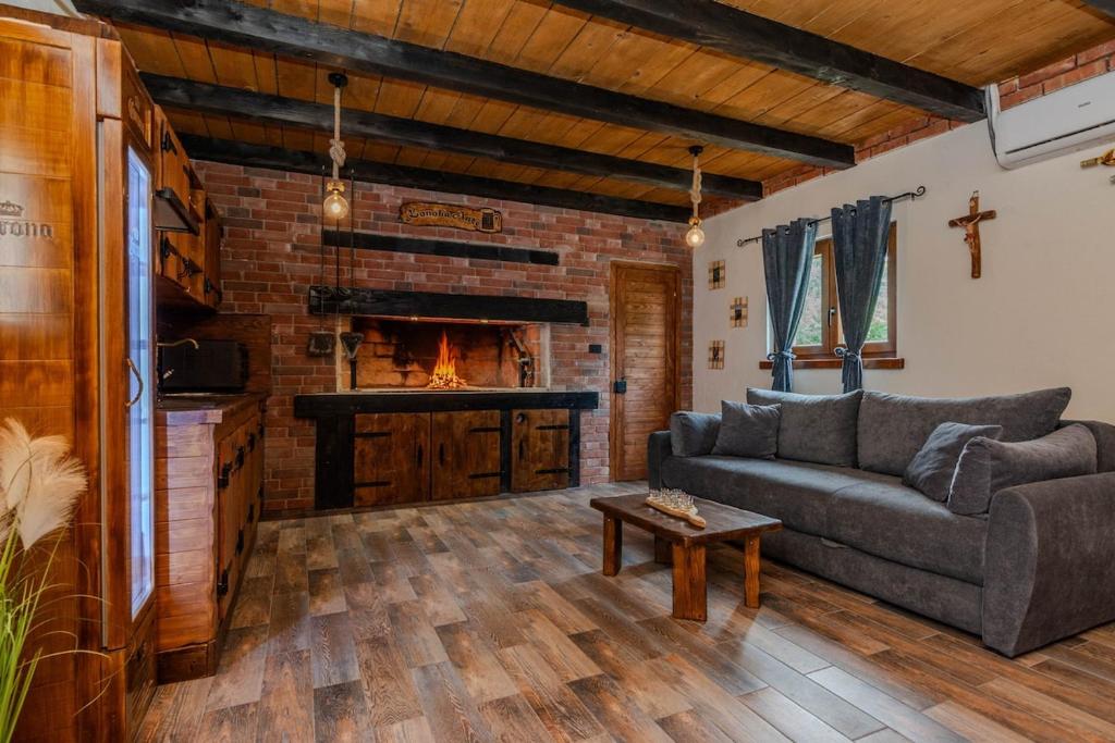 a living room with a couch and a fireplace at Villa Nancy with jacuzzi in Benkovac