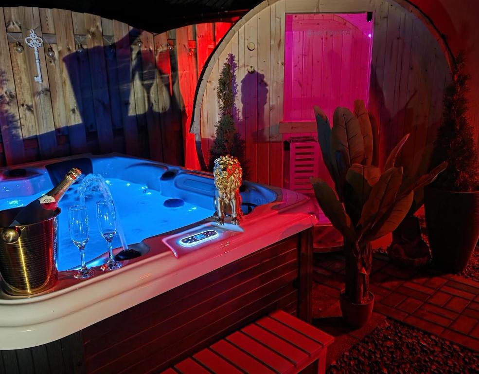 a bathroom with a tub with wine glasses and a cactus at Ferienhaus Mefady Jünkerath in Jünkerath