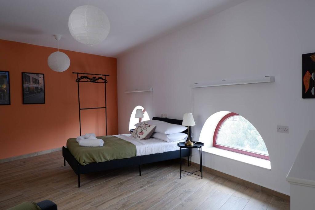 a bedroom with a bed with an orange wall at Peprina Apt 2 in Central Rabat in Rabat