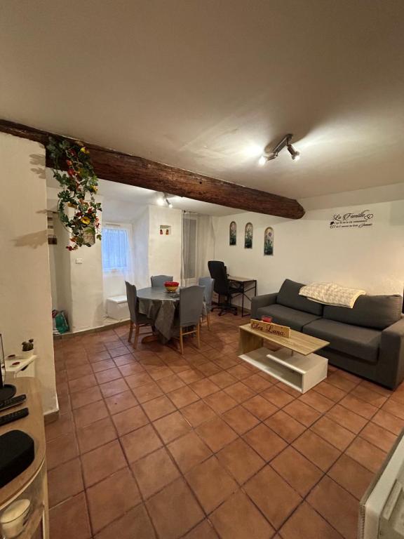 a living room with a couch and a table at Chez Luna in Sisteron