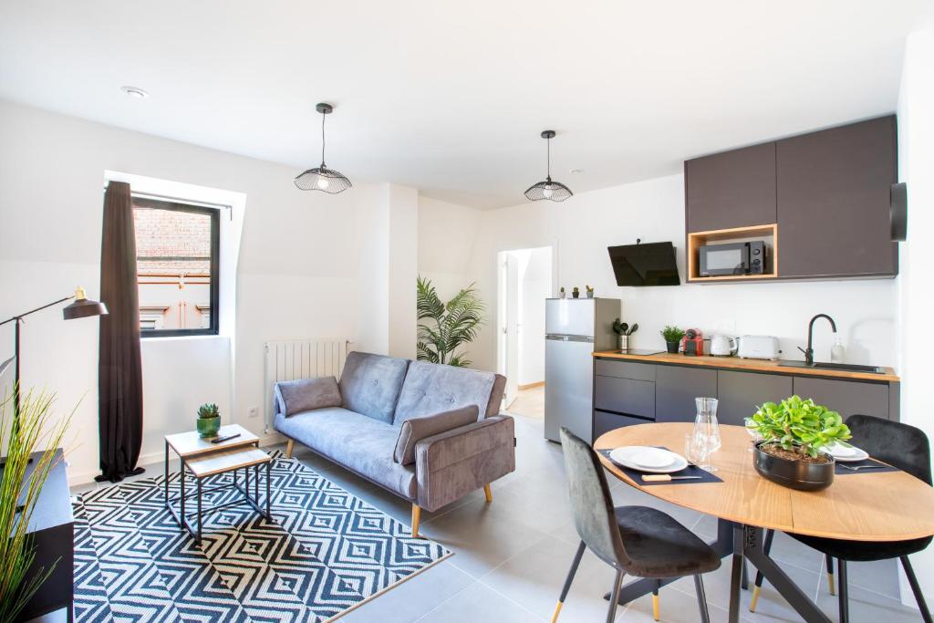 a kitchen and living room with a table and a couch at Romantic getaway with Jacuzzi, Downtown in Mulhouse