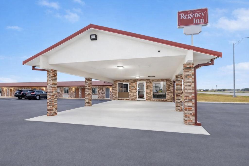 a building with a parking lot at a repair inn at Regency Inn Hondo in Hondo