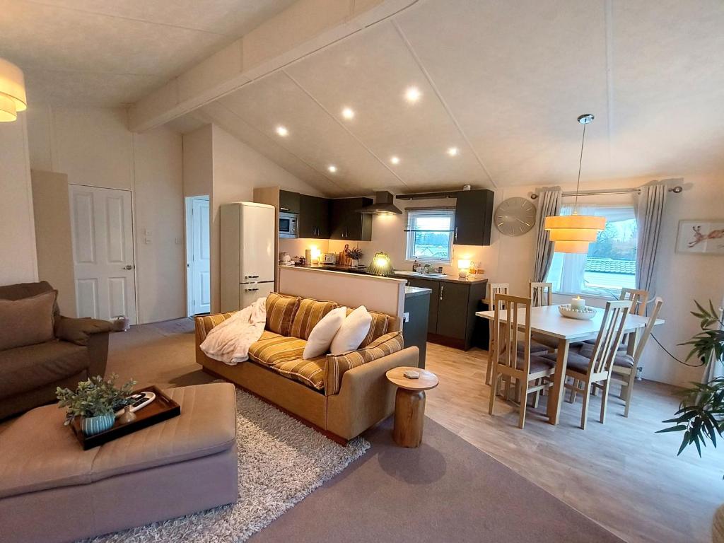 a living room and kitchen with a couch and a table at 10 lochview in Moffat