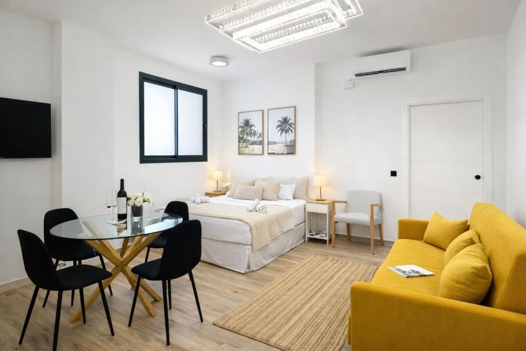 a room with a bed and a table and a couch at Bigbass Valencia Centro in Valencia