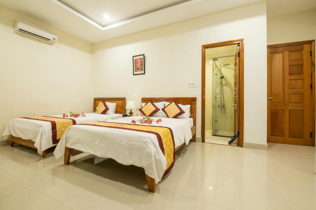 Postel nebo postele na pokoji v ubytování Dam Tien Hotel