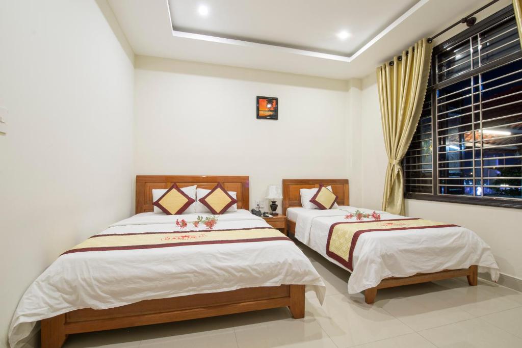 Postel nebo postele na pokoji v ubytování Dam Tien Hotel