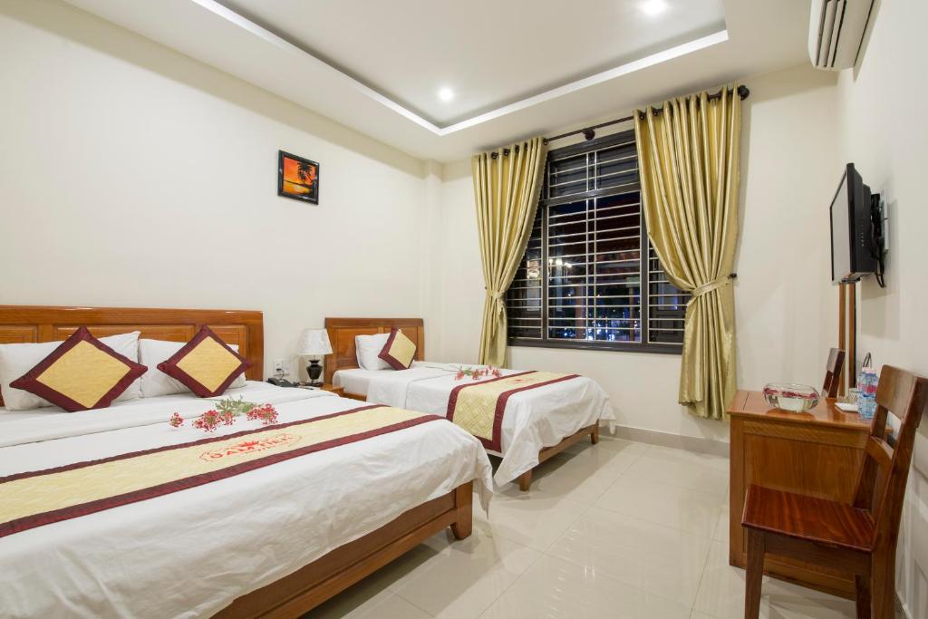 Postel nebo postele na pokoji v ubytování Dam Tien Hotel