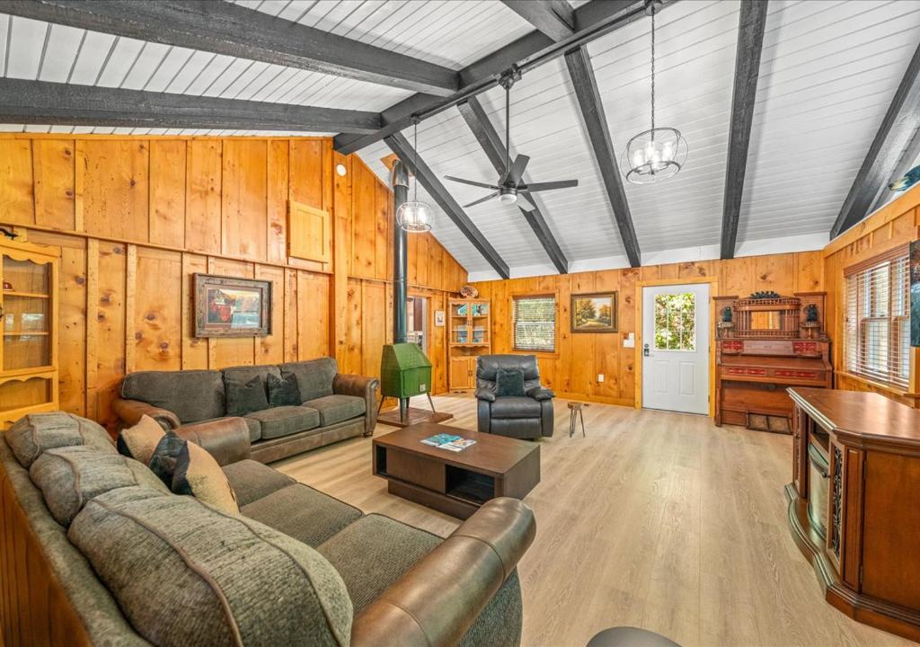 a living room with a couch and a table at Rustic Lodge - Pet-Friendly Cabin with Hot Tub & Fire Pit in Pigeon Forge