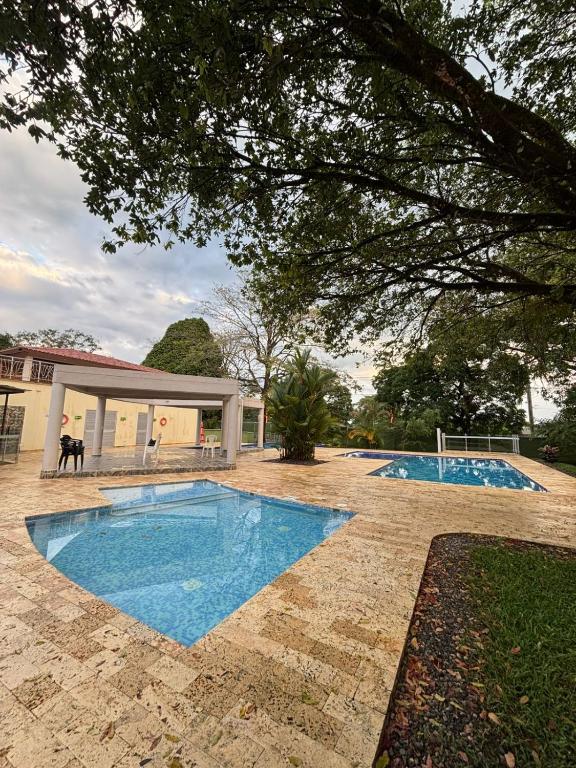 two swimming pools in a yard with a house at Balcones del Bosque 14 -402 in Restrepo