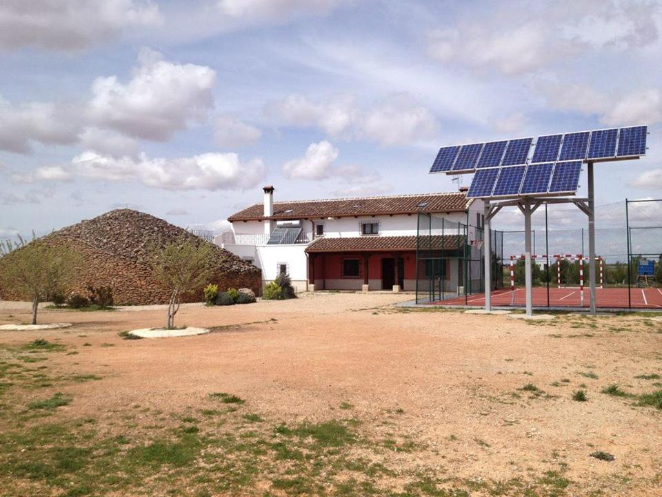 a house with solar panels on top of it at Casa rural EL BOMBO in Tomelloso