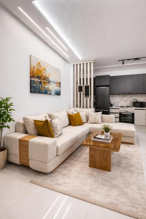 a white living room with a couch and a table at Sirena Apartment Tangier in Tangier