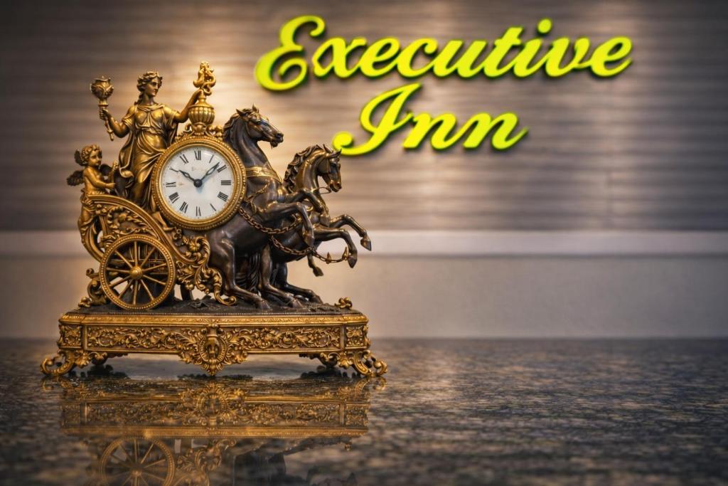 a gold clock sitting on top of a table at Executive Inn Hondo in Hondo