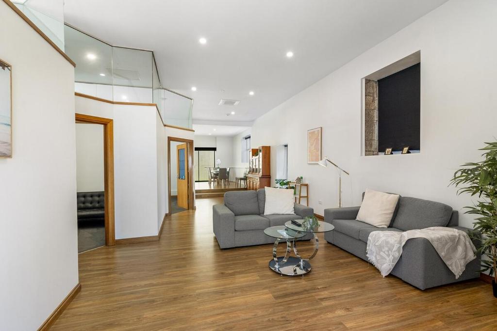 a living room with two couches and a table at Modern refine home in Bellerive