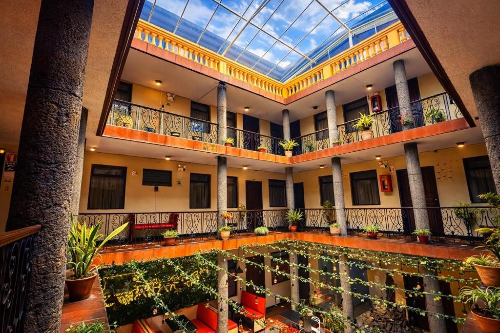 an indoor pool in a building with a glass ceiling at Viena Internacional B&B - Rooftop in Quito