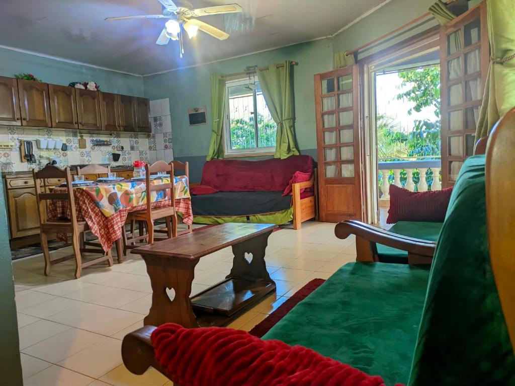 a living room with a couch and a table at Villa Étage Z Irma in Antsiranana