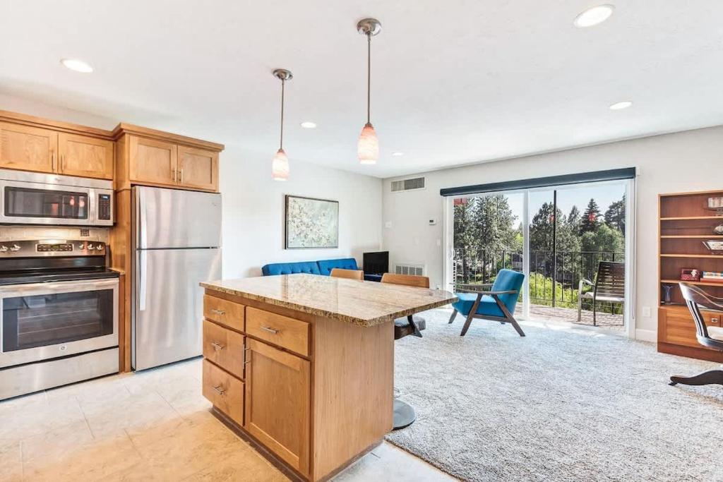 a kitchen with a large island in the middle at Third-floor riverfront condo near downtown Bend in Bend